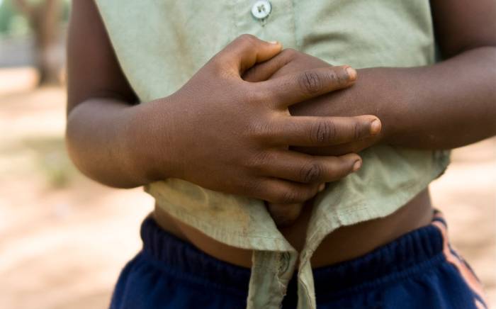Child holding their stomach