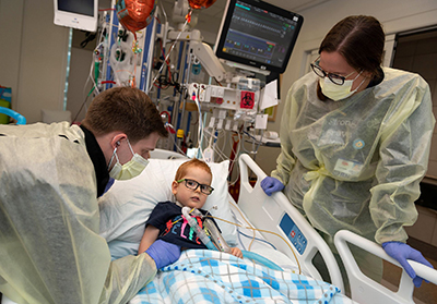 One-year-old pediatric ICU patient Tommy Smith receives care from nurses Zachary Greer and Ginny Seiler. The pediatric ICU team again earned the Beacon Award for Excellence.