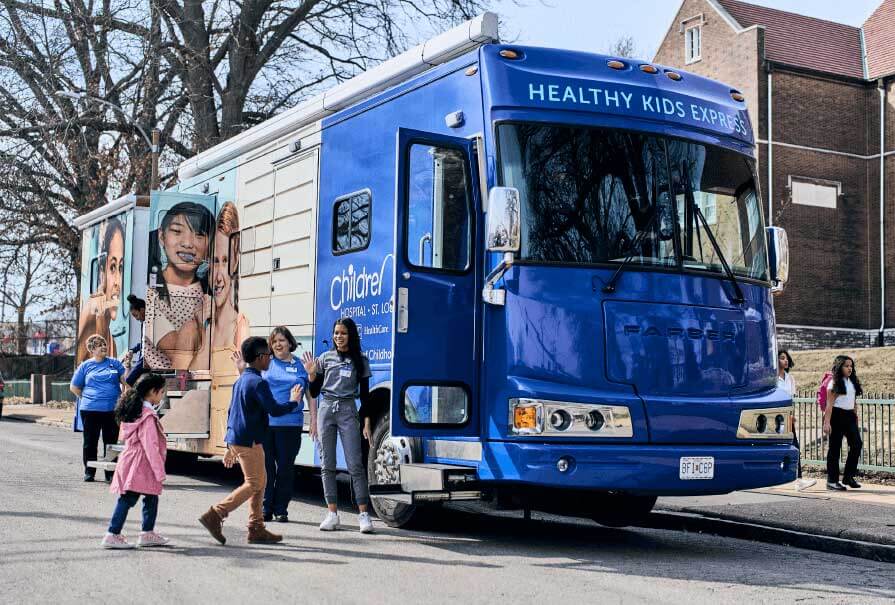 Kids boarding St. Louis Children’s Healthy Kids Express mobile unit