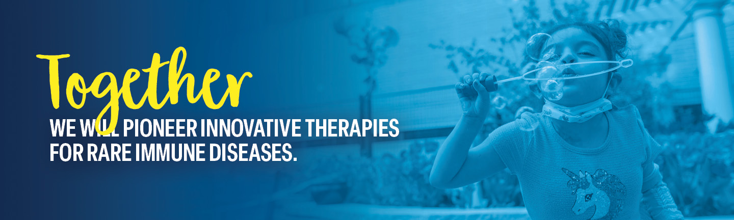 Zoe, a St. Louis Children’s patient, blowing bubbles outside.