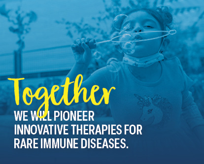 Zoe, a St. Louis Children’s patient, blowing bubbles outside.