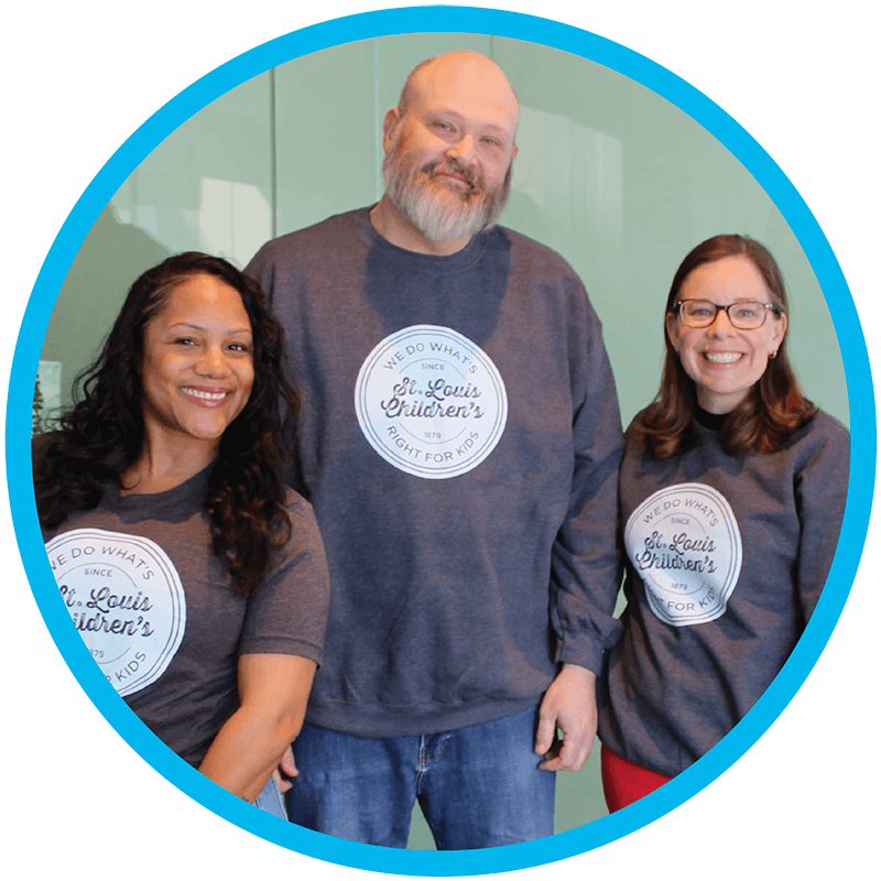 Three people wearing employee giving apparel