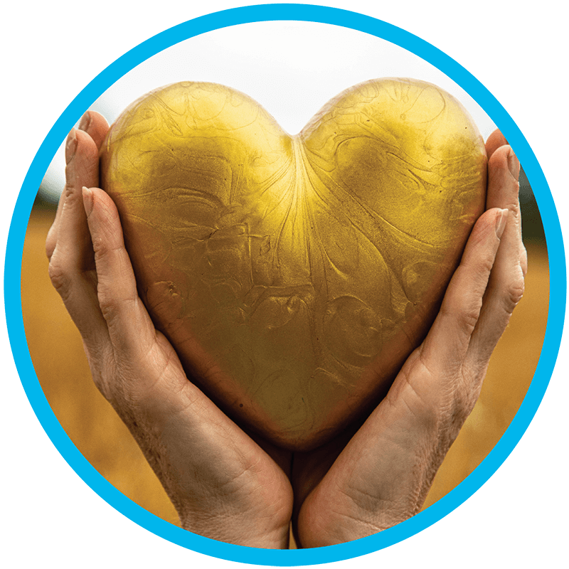 A gold heart held in a pair of hands