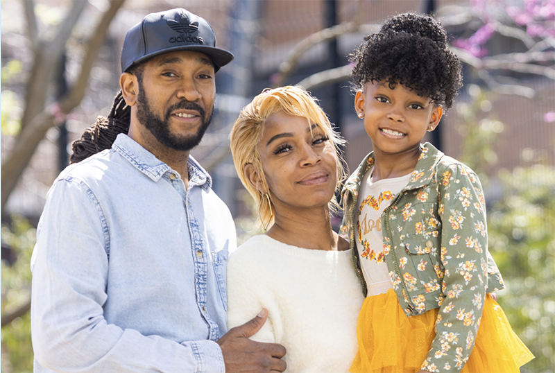 Family standing in front of a building