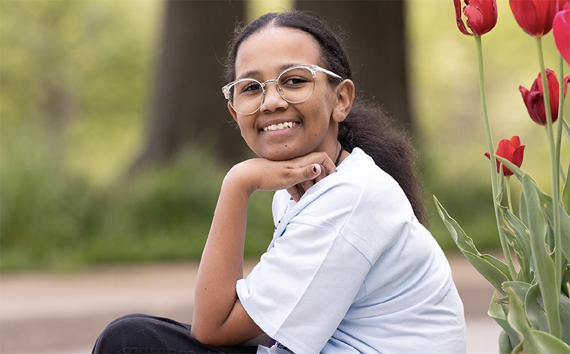 Patient outside on a bench near flowers