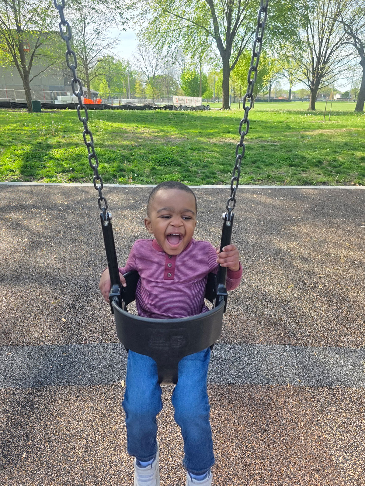 Aveion sitting in a swing outdoors