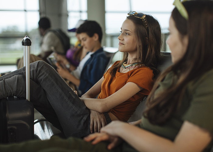 Young woman sitting in the airport gate waiting area