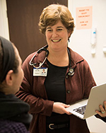 Dr. Katie Plax counsels a teen at The SPOT.  Photo credit: Robert Boston