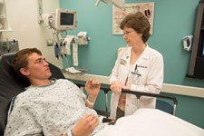 Kimberly Quayle, MD, professor of pediatrics at Washington University School of Medicine in St. Louis, talks to Braden, a patient at St. Louis Children’s Hospital. Braden suffered a head injury in a fall from a ladder. Quayle co-authored a study that looks at head injuries in children and teens. Photo: Robert Boston