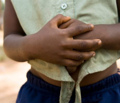 Child holding their stomach
