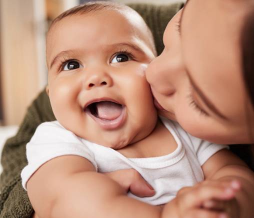 Mom kissing and hugging a baby