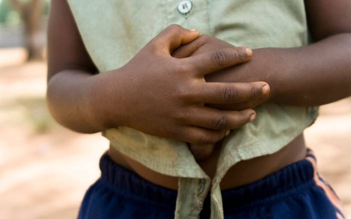 Child holding their stomach