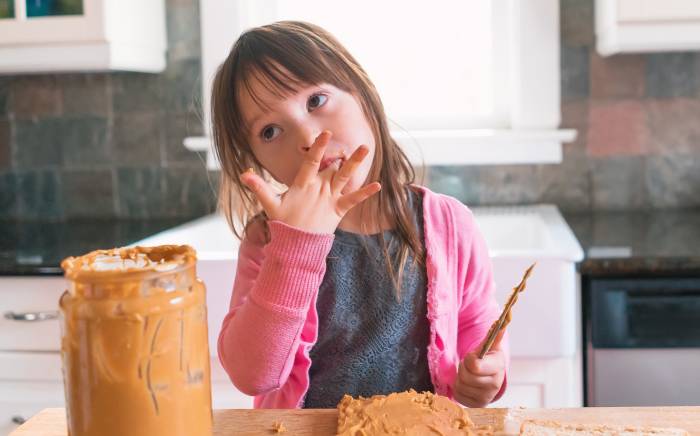 Child eating peanut butter