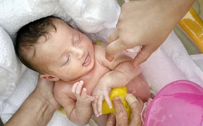 Baby being bathed