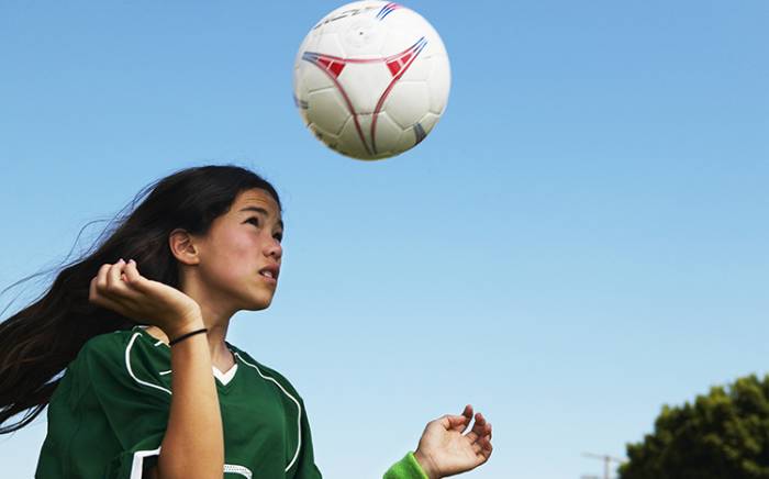 Young girl playing soccer
