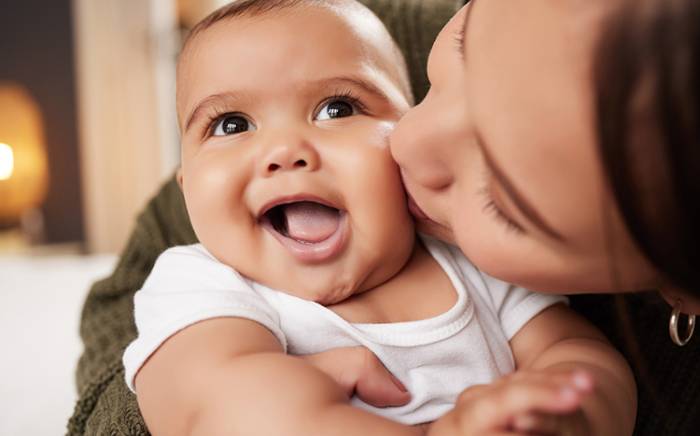 Mom kissing and hugging a baby