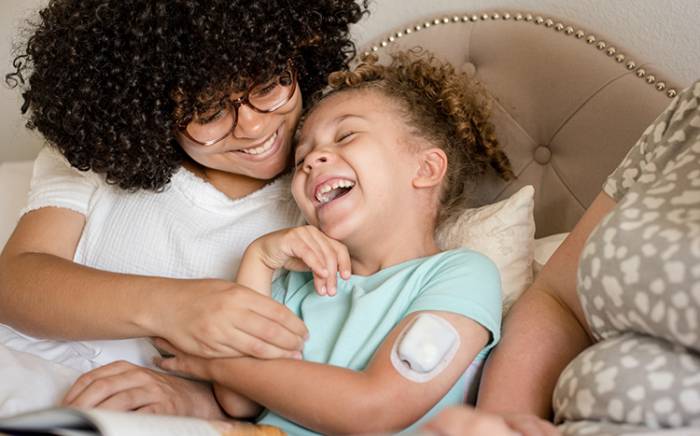 Mom and daughter laughing together